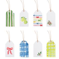 six tags with christmas designs on them hanging from string and decorated with bows, holly berries, pineapples, bell peppers