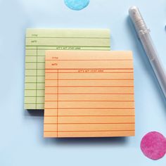 two pieces of lined paper sitting on top of each other