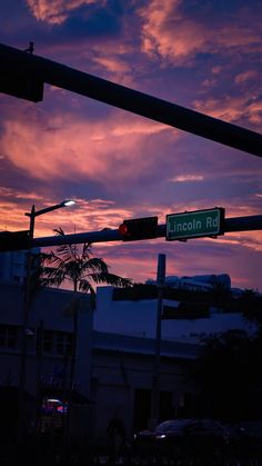 the street sign is clearly visible for all to see as the sun sets in the background