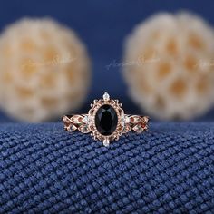 a black diamond ring sitting on top of a blue blanket