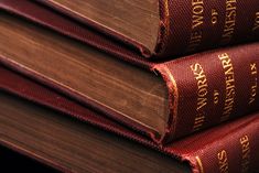 three books stacked on top of each other with the words, world book written in gold