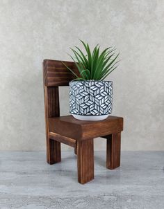 a wooden chair with a potted plant on it