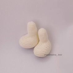 two crocheted white slippers sitting next to each other