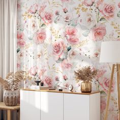 a floral wallpaper with pink flowers and gold accents on a white cabinet in a living room