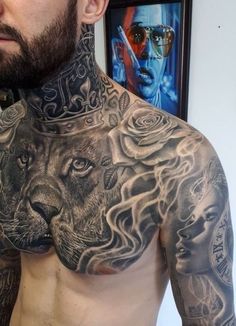 a man with tattoos on his chest has a lion and roses tattoo on his chest