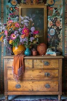 a wooden dresser topped with lots of flowers