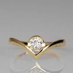 "A handmade 14K gold ring in an impressive, unusual, clean geometric composition featuring a quality round diamond set in a minimalist gold bezel. This is an impressive unique design that will stand out. Diamond - Weight - 0.25ct Clarity - Si1 Color - G If you are looking at this ring then you are probably looking for something special, something different. The engagement rings I design are made of 100% recycled gold and non-conflict diamonds in high quality. After I am sure you have seen a huge variety of engagement rings I am guessing you get the feeling that they all look pretty much alike, maybe you even had the notion that you have seen some designs more than once with different designers. An engagement ring is one of the most cherished, unique jewels which expresses the love and the Modern Yellow Gold Diamond Ring, Modern 14k Gold Diamond Ring With Vvs Clarity, Modern 14k Gold Diamond Ring, Modern 14k Gold Diamond Ring With Polished Finish, Modern 14k Gold Diamond Ring With Bezel Setting, Modern Gold Diamond Ring With Single Diamond, Modern 14k Gold Ring With Tension Setting, Modern Yellow Gold Ring With Single Diamond, Modern Yellow Gold Diamond Ring With Bezel Setting