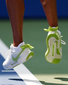 a tennis player's shoes are seen on the court