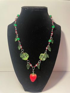 Strawberry necklace made by fairiegems Whimsical Handmade Dangle Necklaces, Whimsical Handmade Dangle Necklace, Whimsical Green Pendant Jewelry, Whimsical Dangle Necklaces With Lobster Clasp, Whimsical Green Jewelry For Gifts, Fairycore Beaded Jewelry Gift, Whimsical Pendant Necklaces For Jewelry Making, Fairycore Pendant Jewelry For Gifts, Whimsical Dangle Necklaces For Gifts