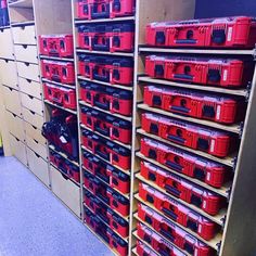 the shelves are full of red tool boxes