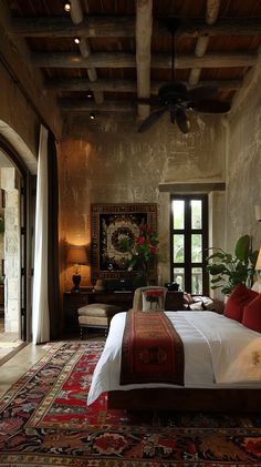 a large bed sitting in the middle of a living room next to a doorway and window