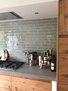 a stove top oven sitting inside of a kitchen next to a wooden cabinet and counter