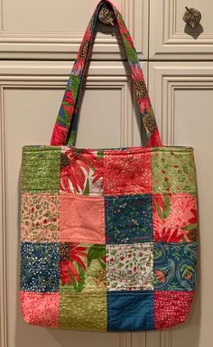 Charm Totes are bags made from Charm Packs, or 42 5" squares from a particular fabric collection. Sixteen are used for the front and another 16 for the back. There is a fusible fleece layer between the outside and the lining which is a coordinating fabric from the collection. There are slip pockets on the inside and the handles are fabric over webbing. The bottom is squared off. These bags are washable and sturdy. I used mine for that extra pair of shoes when wearing boots to work, lunch items, Green Square Fabric Bag, Multicolor Reversible Square Shoulder Bag, Reversible Fabric Rectangular Shoulder Bag, Green Quilted Square Bag, Green Square Patchwork Shoulder Bag, Square Green Quilted Bag, Reversible Multicolor Fabric Shoulder Bag, Square Fabric Bag With Patchwork, Fabric Patchwork Square Bag