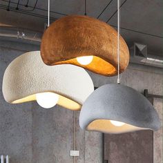 three different colored lamps hanging from the ceiling