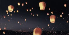 many lanterns floating in the air at night