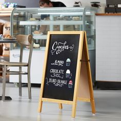 a chalkboard sign in the middle of a restaurant