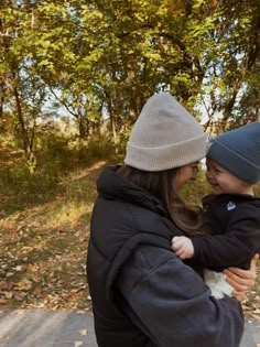 a woman holding a small child in her arms