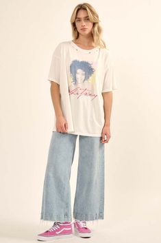 Distressed, garment washed graphic tee. Vintage-style Whitney Houston portrait graphic with signature. Torn and distressed detailing at neckline, cuffs, and hem. Round neckline. Short sleeves. Drop shoulder. Oversized fit. 100% Cotton Imported top designed and printed in LA. Officially licensed Whitney Houston merchandise. Model wears size S. Distressed Graphic Tee, Kiss Logo, Portrait Graphic, Whitney Houston, Iron Decor, Oversized Fits, Drop Shoulder, Round Neckline, Houston