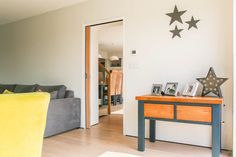 a living room filled with furniture and stars on the wall