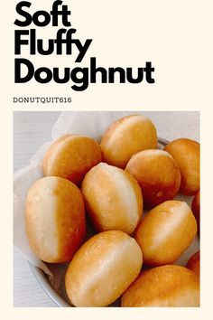 a bowl full of doughnuts sitting on top of a white tablecloth with the words soft fluffy doughnut above it