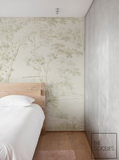 a bedroom with a bed and wallpaper on the walls