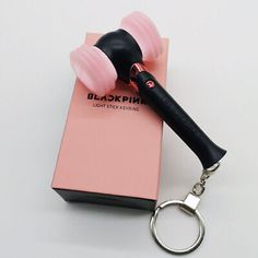 a black and pink hair dryer sitting on top of a box next to a pair of scissors