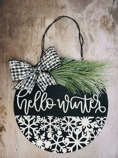 a black and white christmas ornament hanging on a wall with snowflakes