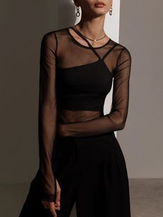 This artful layered slim-fitting top is intricately designed from an almost see-through fabric with a nice feel. Cut with a rounded neckline and extra long sleeves with thumb holes its underpinned with an alluring stretchy crop top with asymmetric shoulder straps for an interesting finish.- slim fit- rounded neckline- long sleeves- crop top with adjustable shoulder straps Sheer Top Outfit, Mesh Top Outfit, Stretchy Crop Tops, Fest Outfits, Long Sleeve Layer, Black Mesh Top, Look Retro, Neue Outfits, Mode Casual