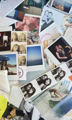 many pictures and papers are spread out on the table together, including one woman's face