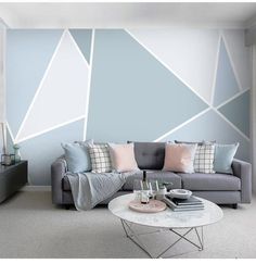 a living room filled with furniture and walls painted in shades of blue, grey and pink