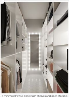 a white closet filled with lots of clothes