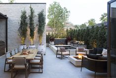 an outdoor patio with seating and fire pit