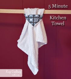 a towel hanging on the wall with 5 minutes kitchen towel