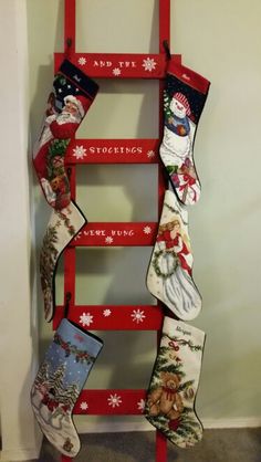 an old ladder is decorated with christmas stockings