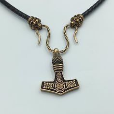 This Mjolnir pendant is reenactment of archeological find based on artifacts from 10th century Denmark. The Hammer of Thor is made from Italian bronze, this is high quality replica. The necklace is made from leather cord. The Thors Hammer in Viking age was used as amulet for men and women. If you like Norse or Nordic jewelry - you`ll like this item. The item shipped in wooden jewelty box, so it`s perfect mens gifts option. The are wolf, raven, dragon, goat, bear necklace variations. Thors hammer Bronze Viking Jewelry Collectible, Viking Style Bronze Jewelry Gift, Viking Style Handmade Gold Jewelry, Handmade Viking Gold Jewelry, Handmade Viking Style Gold Jewelry, Gold Viking Style Necklace For Gift, Handmade Viking Style Bronze Jewelry, Viking Pendant Necklace Collectible, Viking Style Pendant Necklace Collectible