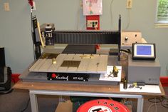 a machine that is sitting on top of a table in front of a red frisbee