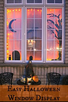 an easy halloween window display with fake pumpkins and lights in the windows, outside