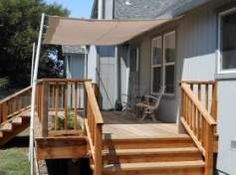 a wooden deck with steps leading up to a house