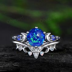 a ring with an oval blue opal surrounded by white topazte and diamonds