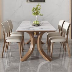 a marble dining table with four chairs around it