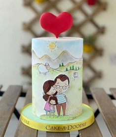 there is a cake with a couple on it and a heart above the top that says cake - a - doodle