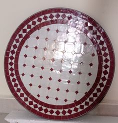 a red and white plate sitting on top of a counter