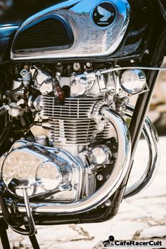 the front end of a black motorcycle with chrome trim