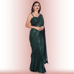 Introducing the exquisite "1 Minute Sequin Saree - Iridium"! ✨ Crafted from luxurious georgette, this saree combines timeless elegance with modern convenience. Designed for the busy fashionista, it comes pre-stitched for hassle-free draping. The dazzling iridium sequins glisten with every step, ensuring you steal the spotlight wherever you go. 💃Complementing this beauty is a classy spaghetti strap blouse that adds a touch of sophistication and allure to your ensemble. ✨Ideal for weddings, parti Elegant Green Pre-draped Saree For Celebration, Glamorous Georgette Pre-draped Saree For Celebration, Green Cutdana Pre-draped Saree For Evening, Glamorous Semi-stitched Pre-draped Saree With Cutdana, Glamorous Cutdana Saree For Festive Occasions, Formal Floor-length Pre-draped Saree For Diwali, Glamorous Festive Saree With Cutdana, Festive Glamorous Saree With Cutdana, Formal Pre-draped Saree With Sheer Dupatta In Georgette