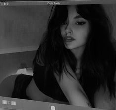 a black and white photo of a woman with long hair on a computer monitor screen