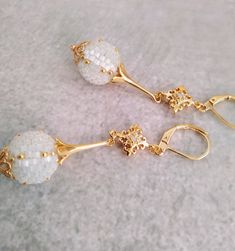 Sleek sellouts! 🤓. Order White bead ball earrings 24 k gold filling Ethnic style beaded at €75.0 #EthnicStyle #MosaicEarrings #WickerJewelry #ChandelierEarrings #SeedBeadMaking #GoldFilling #MosaicMaking #FolkloreJewelry #24kGold #BeadedEarrings Traditional Gold Earrings With Faceted Beads, Elegant White Earrings With Faceted Beads, Festive Elegant Round Beaded Earrings, Elegant Gold Beaded Earrings With Faceted Beads, Elegant White Earrings With Gold Beads, Elegant Round Beaded Earrings With Faceted Beads, White Round Earrings With Gold Beads, White Gold Beaded Round Earrings, Romantic Style Outfit