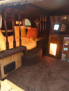 the interior of an rv with couches, television and other items on display in it