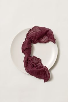 a white plate topped with a purple scarf