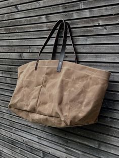 This XXL tote bag is made from American heavy weight waxed canvas,(18oz) The color is tan. The design was inspired on the blue IKEA shopping bag, I used around the same size Perfect for a trip to the market, work, or even big enough for weekend away, . All the bags are made and designed by myself and handmade with care one at a time and attention for details. The carry all measures approximately 54 cm wide, 43 cm tall and 35 cm deep, at the bottom. In inches this is 21,2 inches wide, 16,9 inches Khaki Canvas Bag With Handles, Khaki Canvas Bag, Large Capacity Waxed Canvas Weekender Bag, Large Capacity Waxed Canvas Weekender Bag For Everyday, Everyday Waxed Canvas Bag With Reinforced Handles, Everyday Large Capacity Waxed Canvas Weekender Bag, Waxed Canvas Tote Weekender Bag For Daily Use, Waxed Canvas Tote With Reinforced Handles, Beige Waxed Canvas Bag With Leather Handles