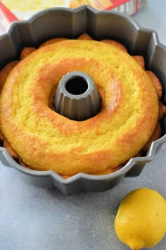 a bundt cake in a pan with a lemon next to it